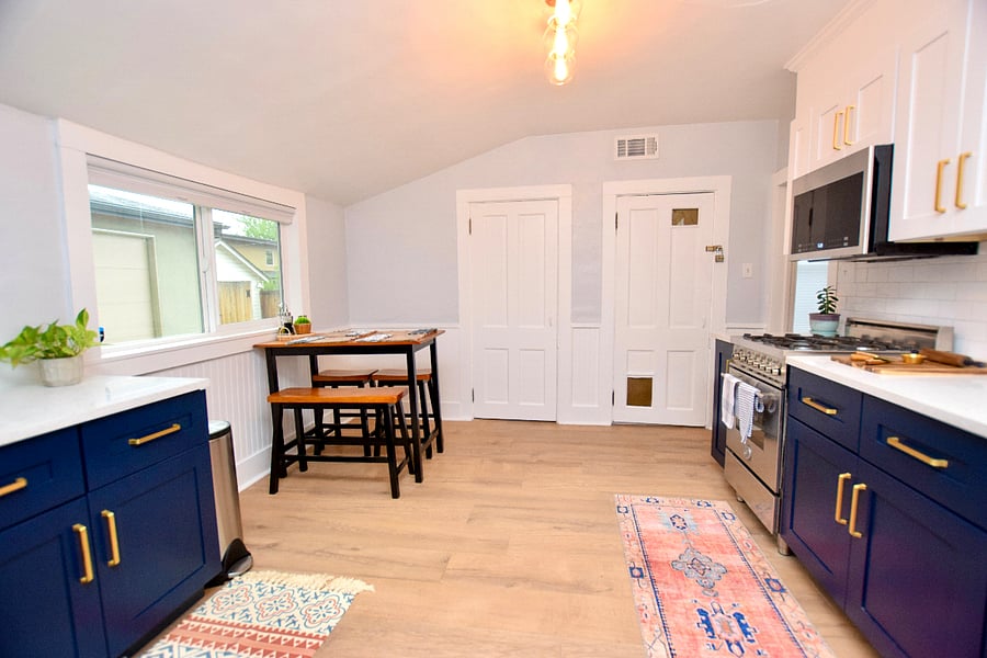 Dining table, door on the left is the pantry/laundry room with washer and dryer