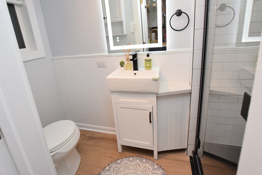 Completely remodeled bathroom, everything is new. The mirror has a touch display to add more lighting. To the left is vanity above toilet for storage.
