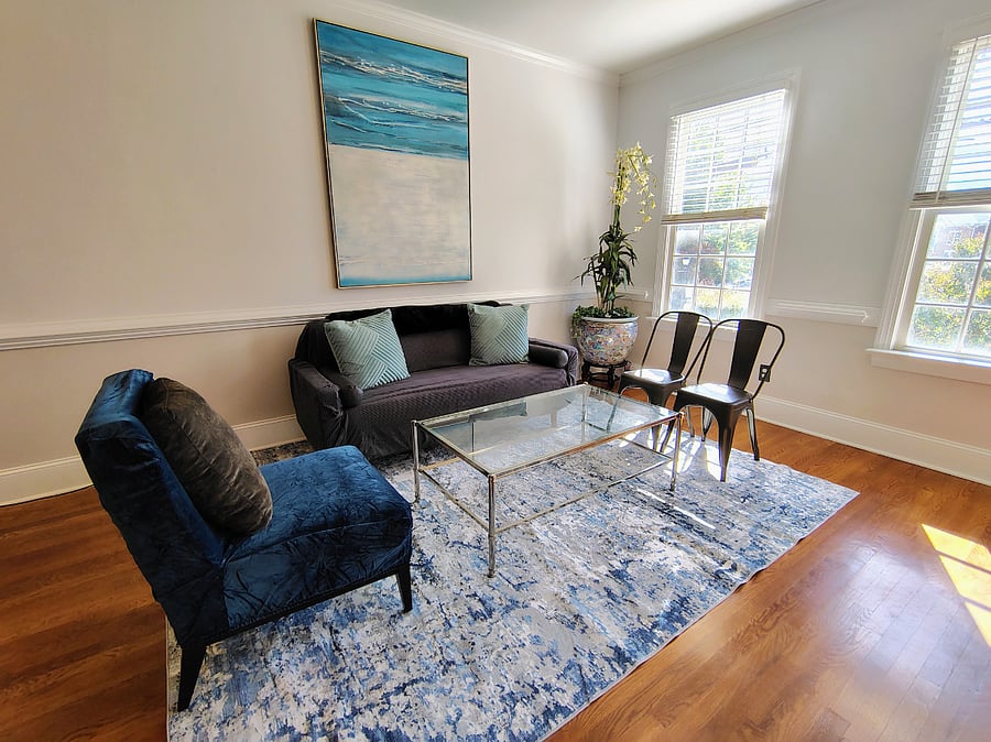 Living room view features beautiful light and real hardwood floors
