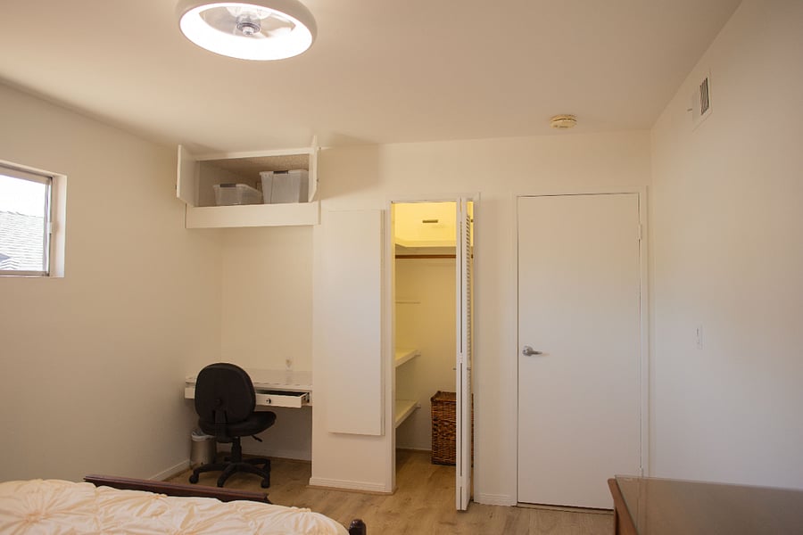 Bedroom Closet and overhead storage cupboard