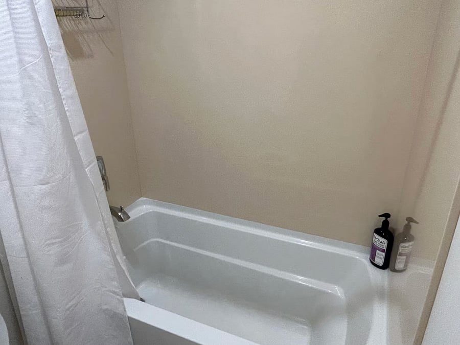Tub over shower in your bathroom.