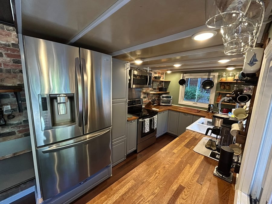 Cook as much as you like in this large kitchen with full sized appliances, ample counter-space and more cabinets than any tiny house should have.