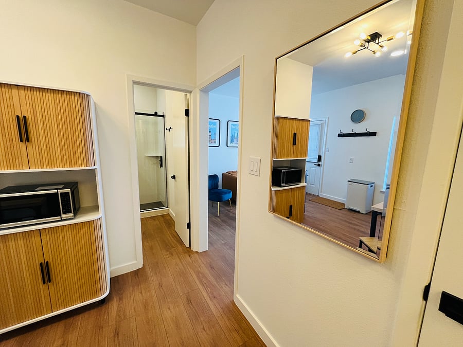 Hallway with Kithen (left), Bathroom (straight ahead), and Living Room (right)