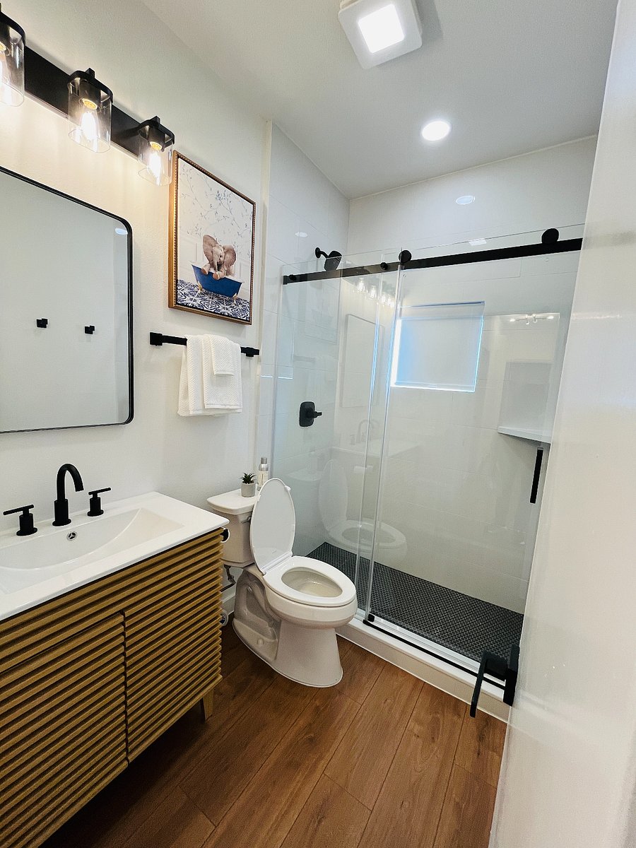 Newly Renovated Bathroom with Kohler toilet and standup shower with glass sliding door