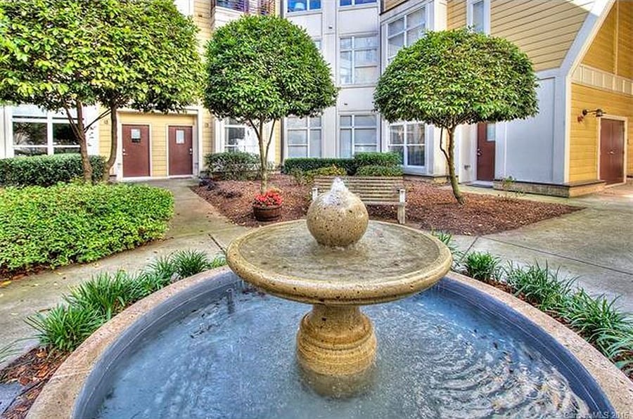 Relax in the secluded courtyard with lots of green space and a water feature.