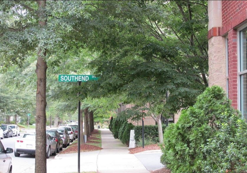 Condo building is surrounded by green spaces and classic southern tree-lined boulevards.