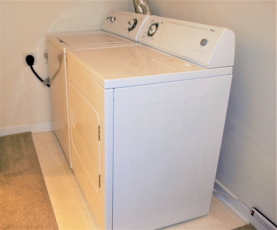 Washer and dryer in large walk-in closet (includes wooden hangers, storage, iron and ironing board.)