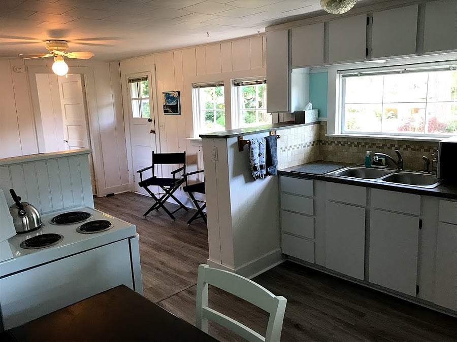 Kitchen includes oven and stove and small table with 2 chairs