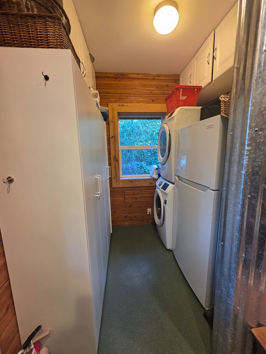 Utility room next to kitchen houses a pantry and 2nd full sized fridge, both for tenant's use.