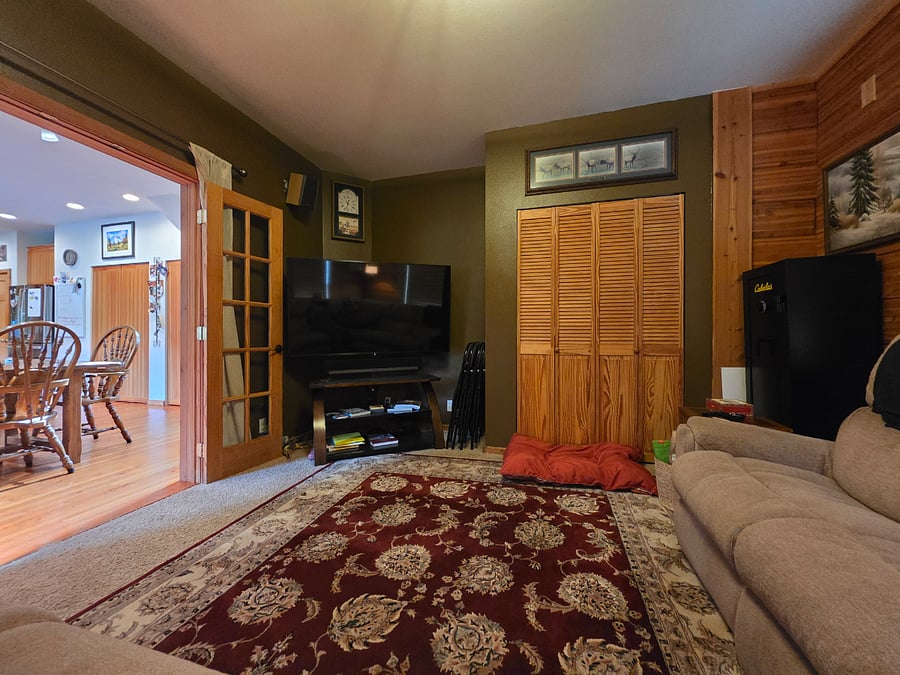 Shared family room featuring smart tv with surround sound and boardgames in the closet.