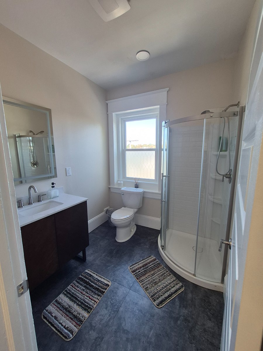 Bright and sunny new bathroom with smart mirror and ample storage