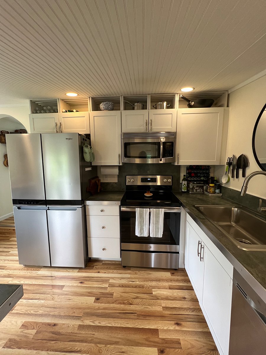 Kitchen with newer appliances including dishwasher. Fully-stocked with accessories