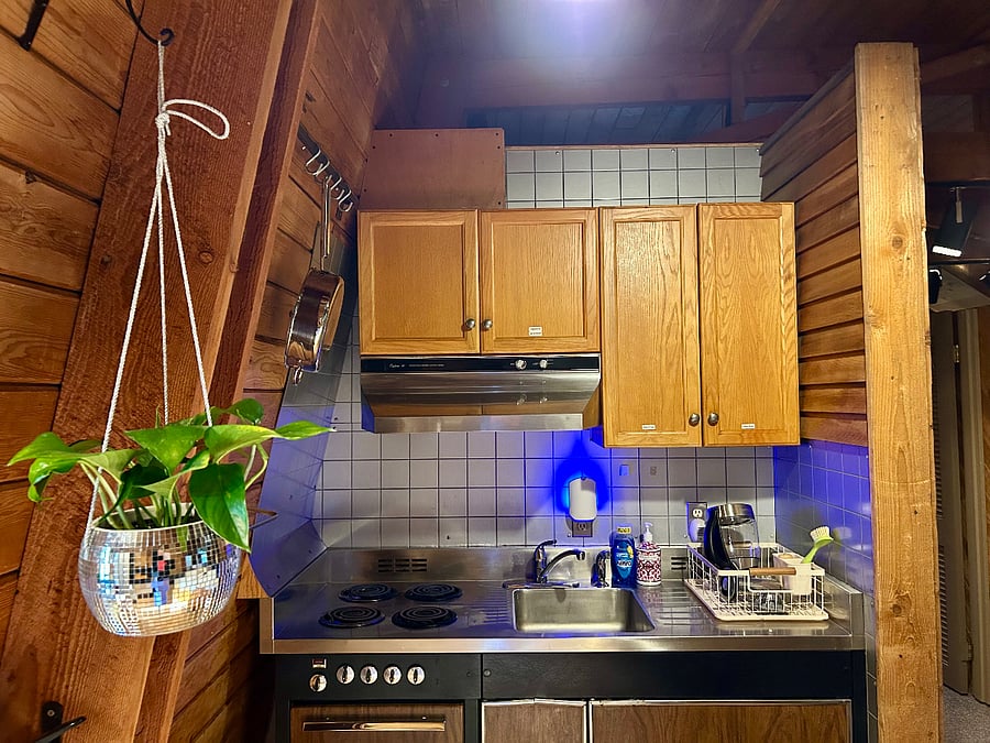 Kitchenette: Oven, stovetop, stocked cabinets, and dish sink