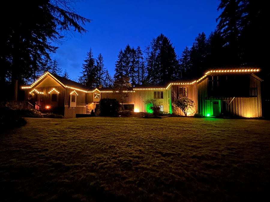 Lawn: View of the lit up house at night, which is enjoyed year round