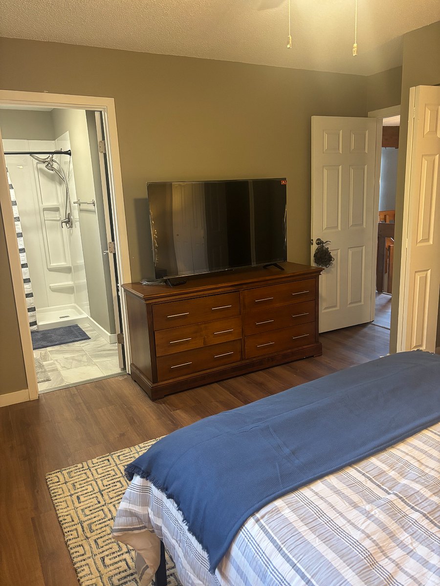 Upstairs, the main bedroom with a view of the en-suite full bath