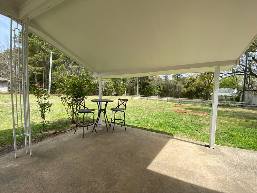 Carport with sitting area and large back yard