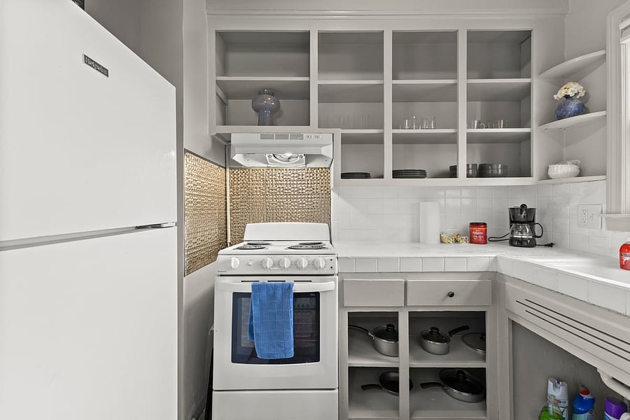 Clean, functional kitchen with cookware, coffee maker, and full-size appliances perfect for travelers who enjoy the comfort of home-cooked meals.