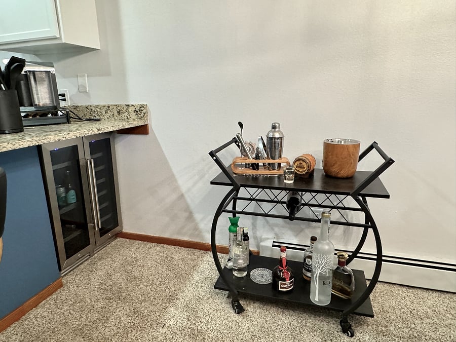 Bar cart and 2 zone beverage fridge - one side for wine, one at refrigerator temp for cold drinks.
