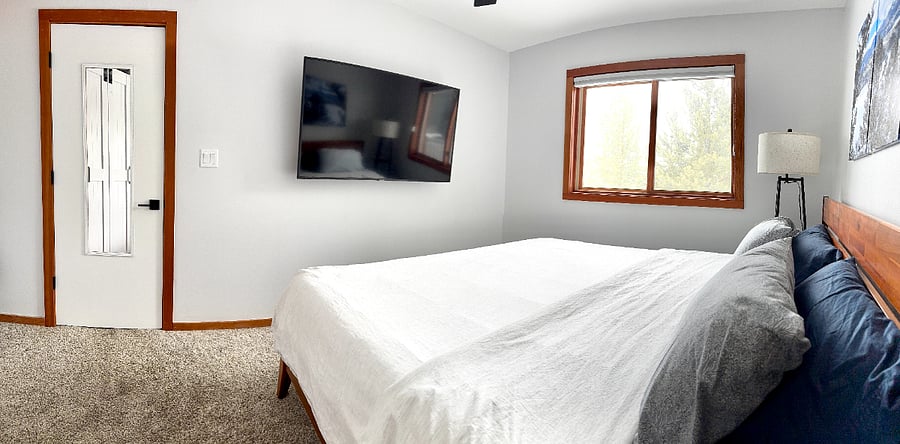 Primary with smart TV, looking out toward Peak One.