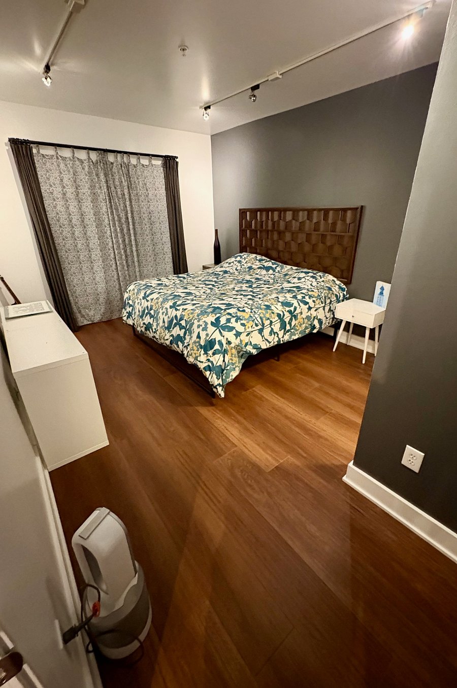 View from the doorway into the large bedroom.
There are 4 layers of window coverings for a near "black out" effect.