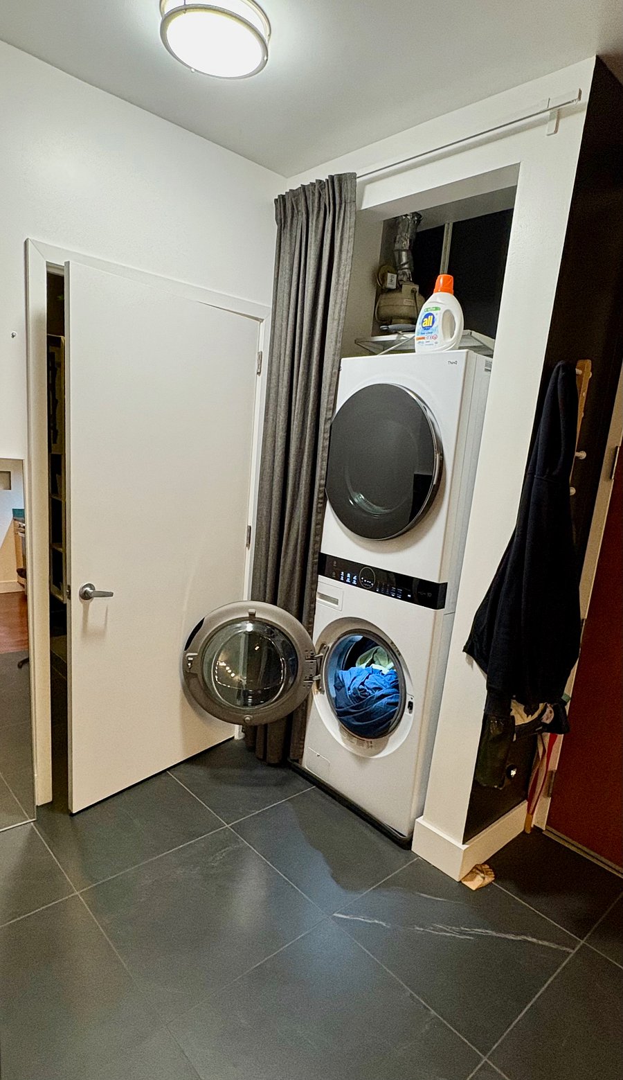 Full size steam washer & dryer just outside the bathroom.