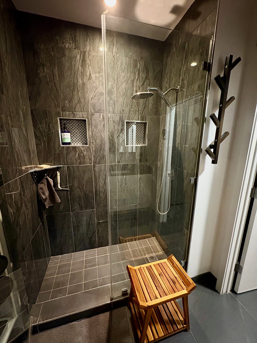 Walk-in shower ( with VERY hot water provided by the building's central heater just below the unit in the garage ;- )
Need to just sit under the water? The bench is teak and ready to join you!
