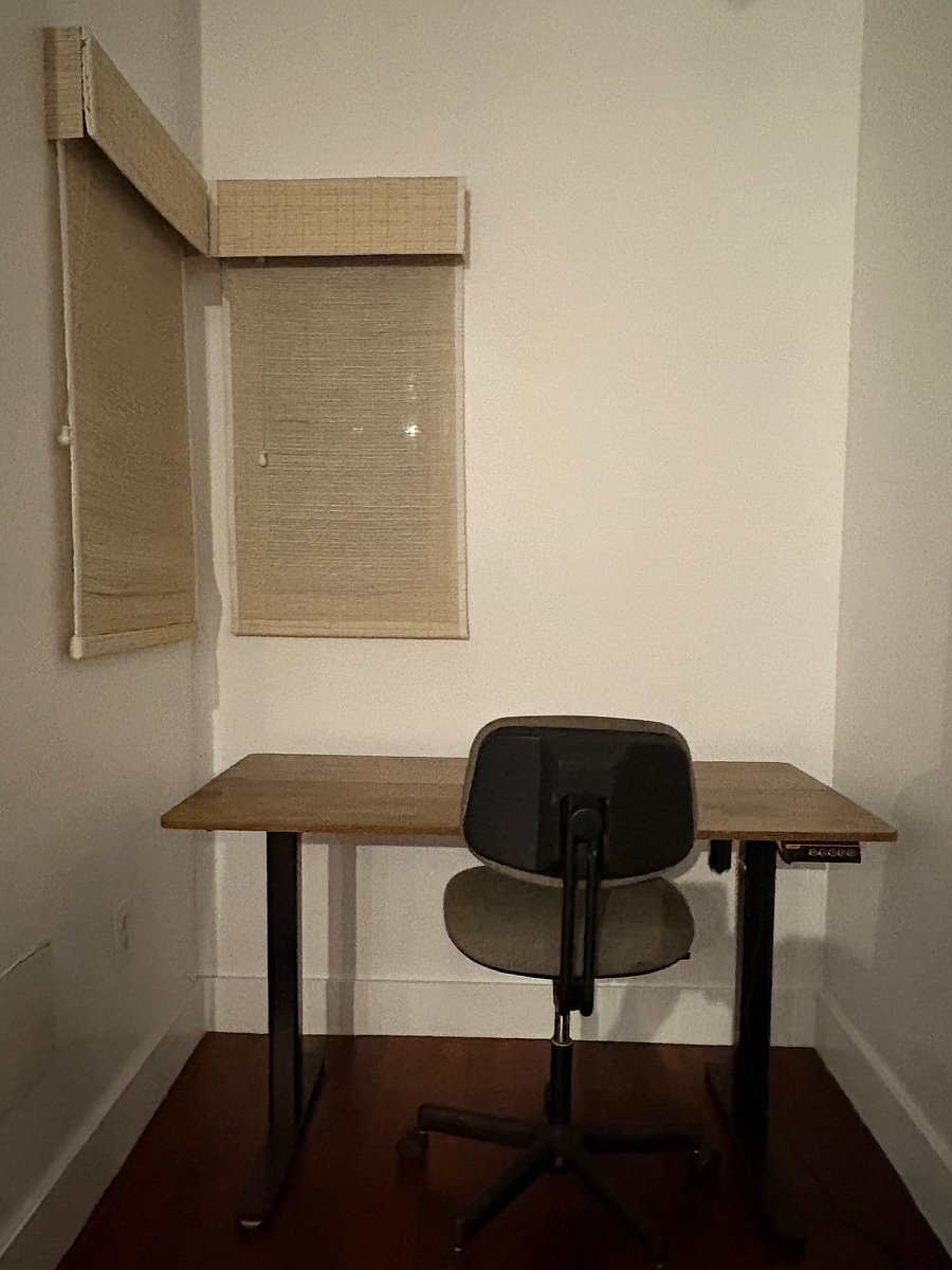 Small office nook on the exterior wall by the door to the porch with a sit-stand desk and plenty of light.