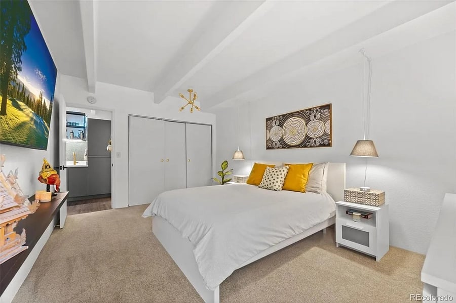 The Thai-inspired master bedroom is off the hallway with wet bar, linen closet, and bathroom. Ample closet in view with built-in organizer.