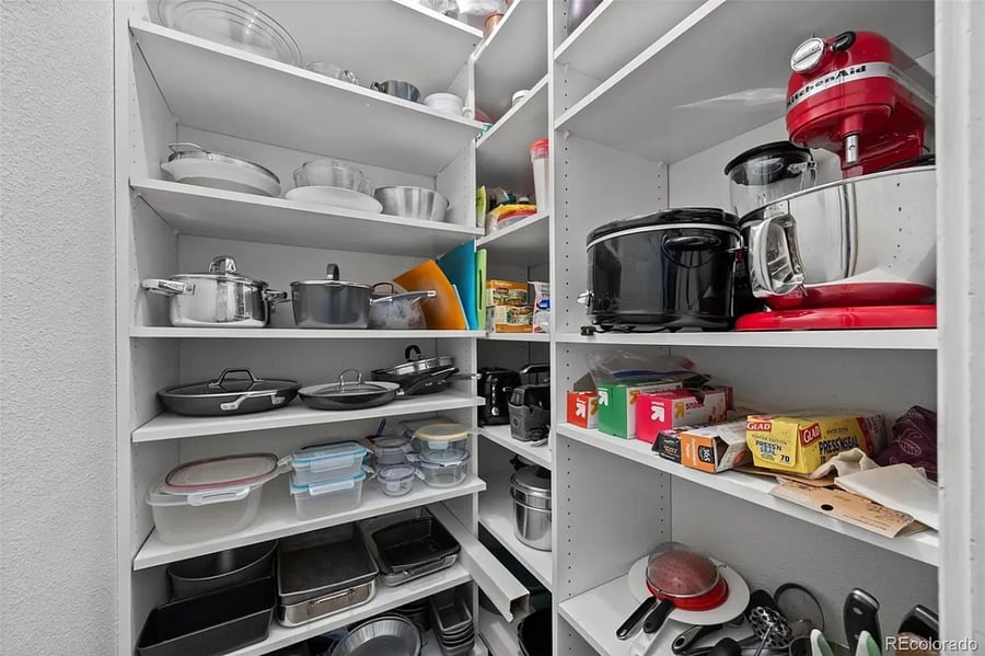 On the left upon entering the condo, steps from the kitchen, one finds a well-stocked, spacious pantry.