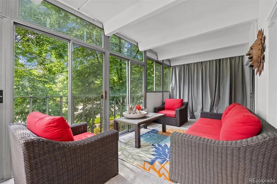 This three-season sun room is flooded with light and a wonderful spot for morning meditation and coffee. The curtains in the background provide storage for large items.