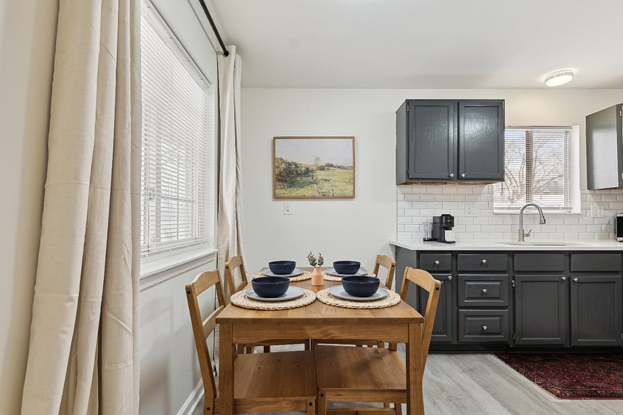 View of dining area and kitchen from front entrance.