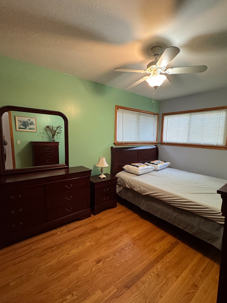 Second bedroom with queen size bed, bureau and nightstand.