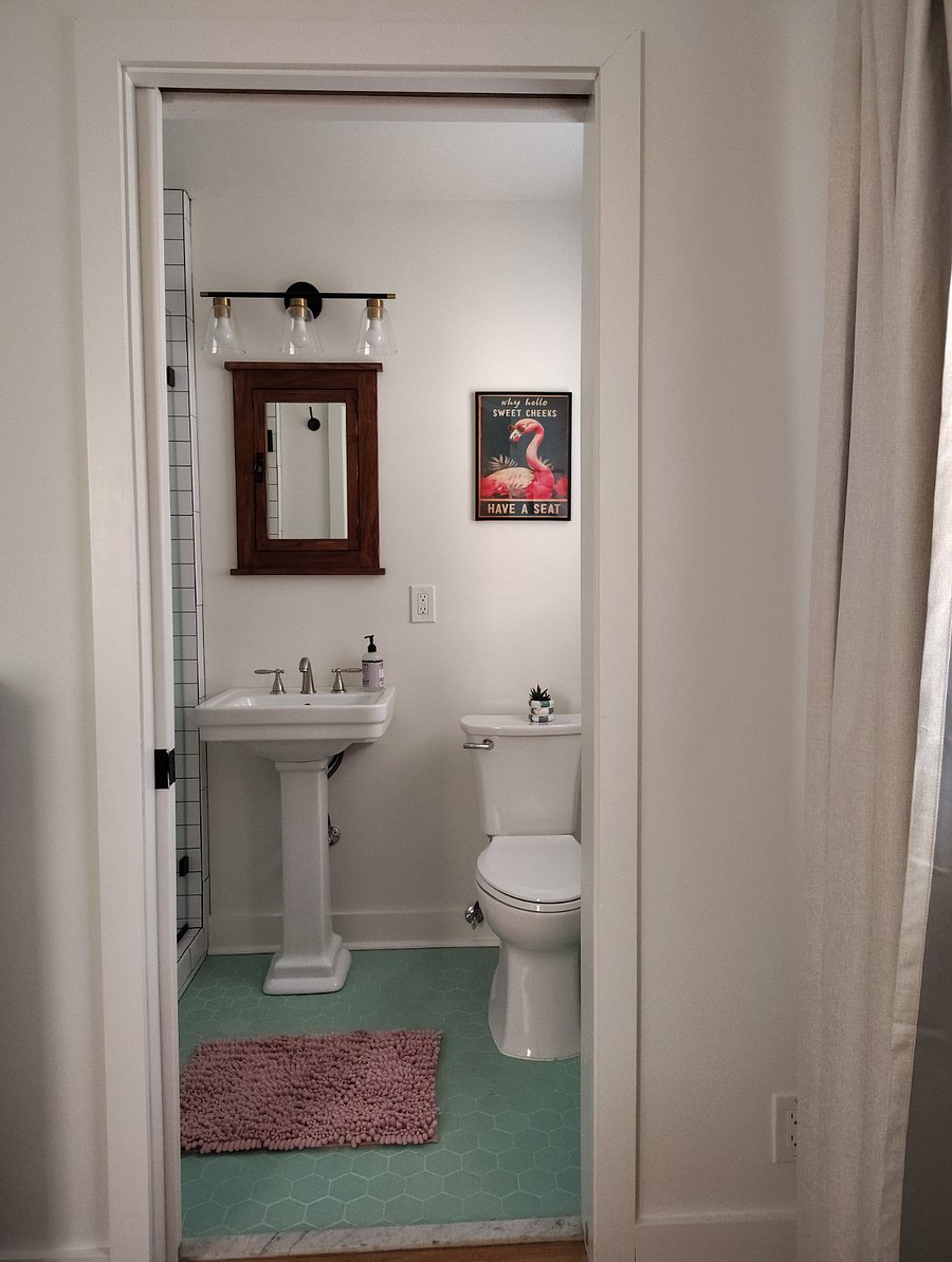 Adorable en suite bathroom with original vintage 1950s hexagon tile floor.