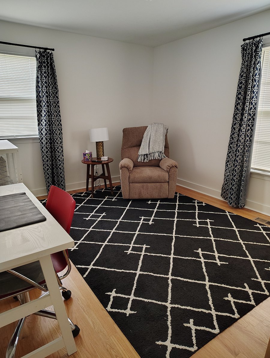 Private sitting room with recliner, desk, mini-fridge, Keurig, microwave, and cupboard/pantry.