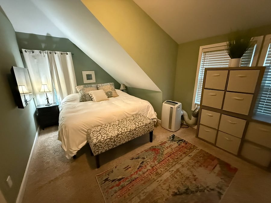 Bedroom 1 - King bed, TV, closet, and AC unit for extra cooling