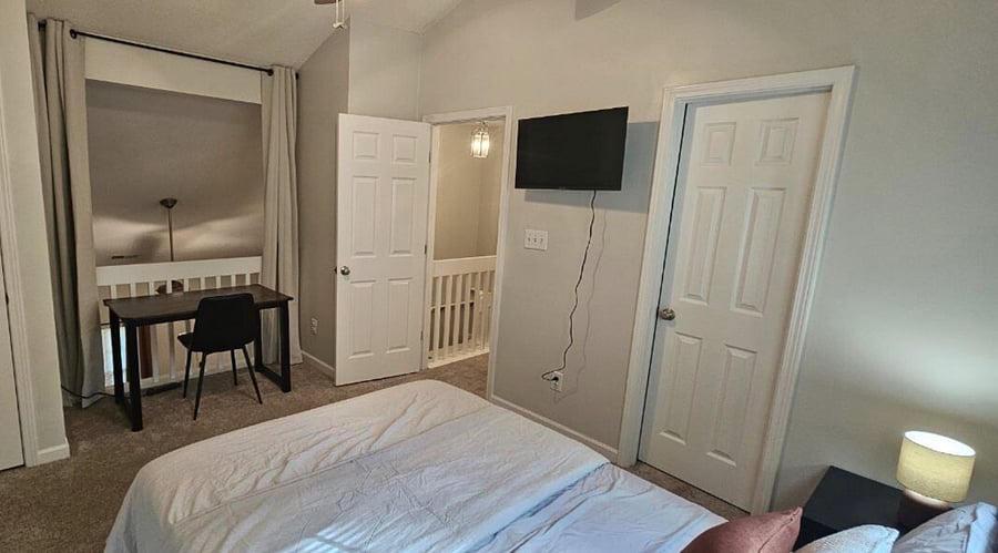 Lofted bedroom w/ open balcony and blackout privacy curtain.