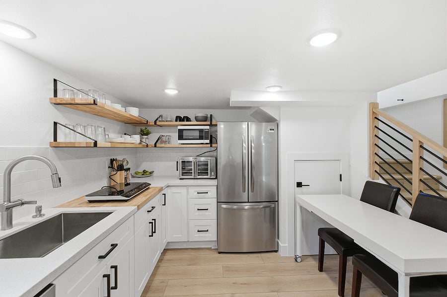 Kitchen with new appliances and dining table.