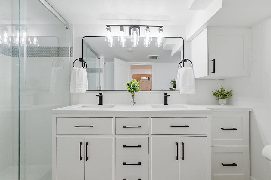Double sink vanity in the bathroom with great light.