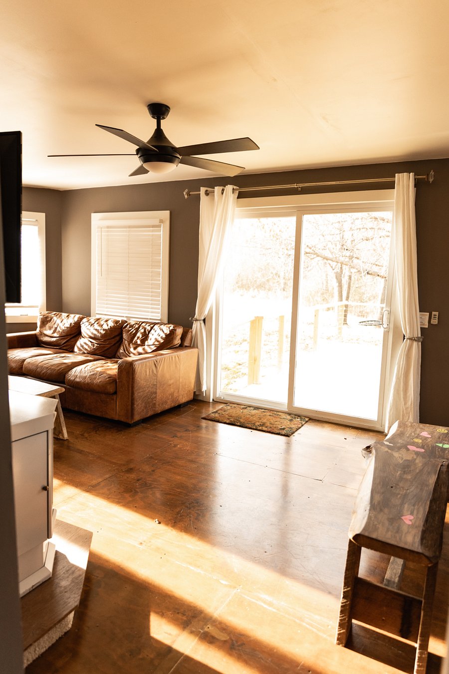 Living room off kitchen, doors lead to deck