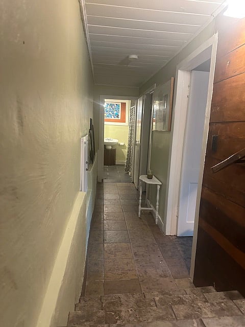 Stairs off living room that Leeds to bedrooms and bathroom