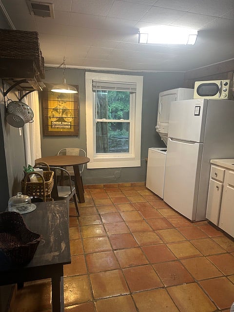 Kitchen including the washer and dryer.