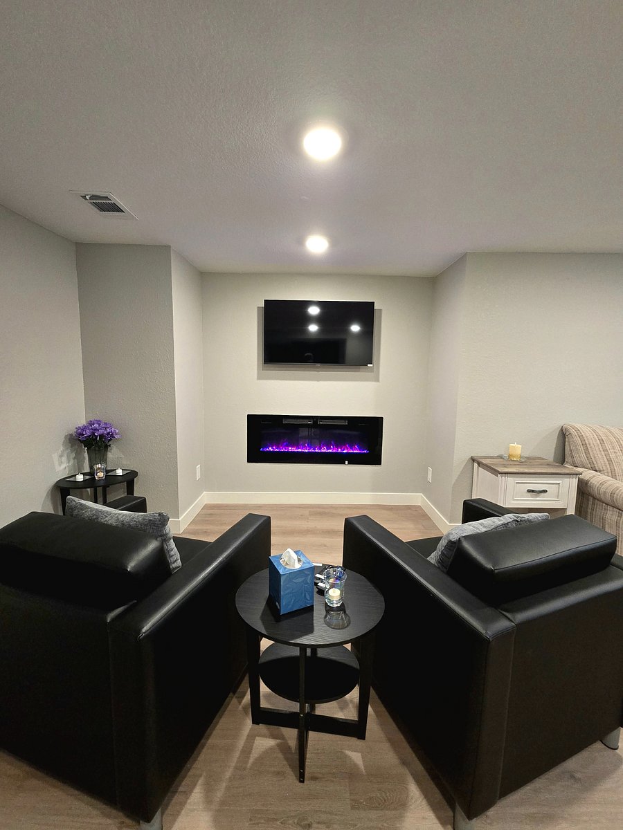 Basement lounge area with electric fireplace