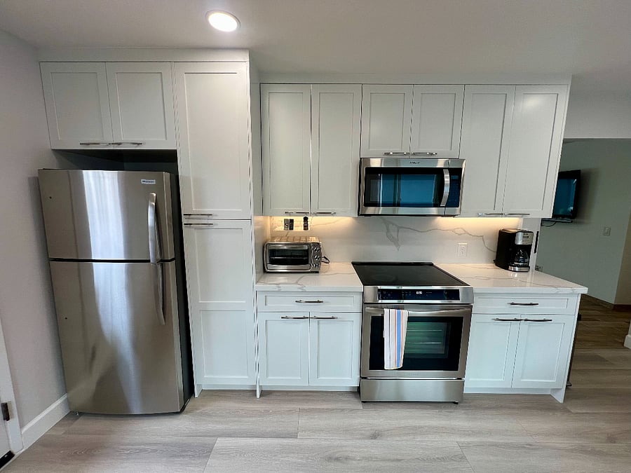 All NEW kitchen with quartz countertop, microwave, refrigerator, induction stove and oven.