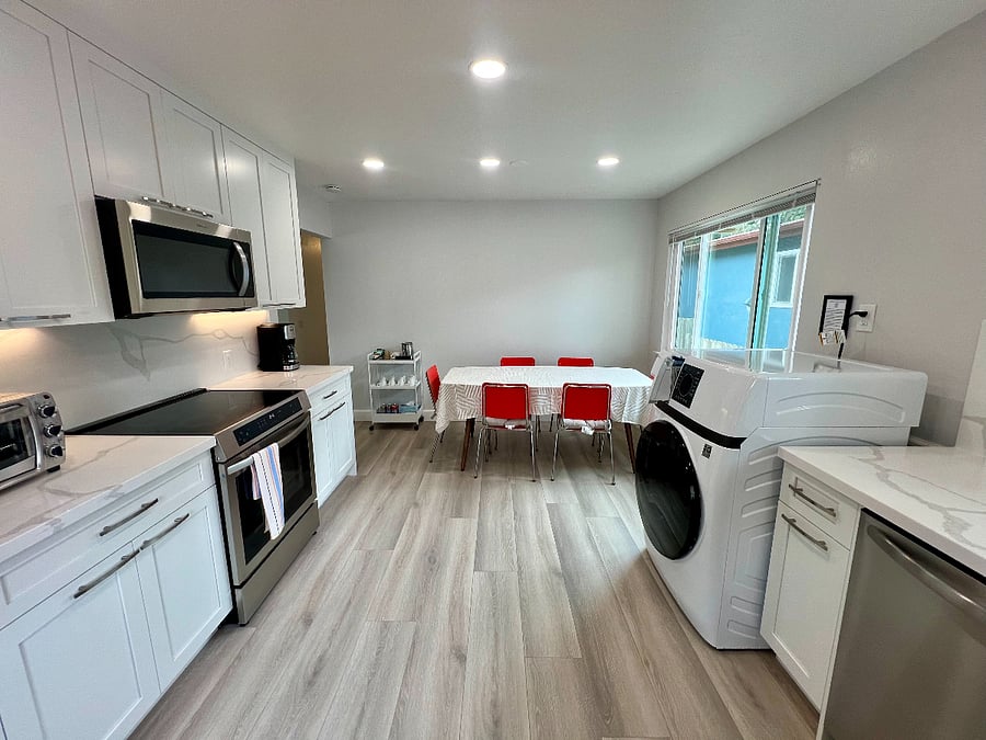 A spacious and bright kitchen and dining area.