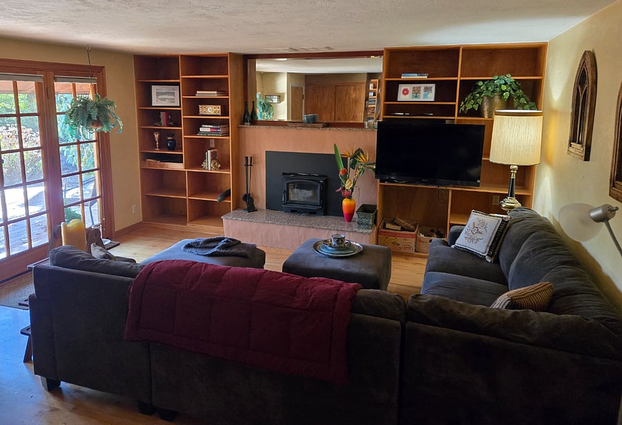 Full height windows and door onto the deck with screen. Living inside and out year round with covered seating under the eaves also.