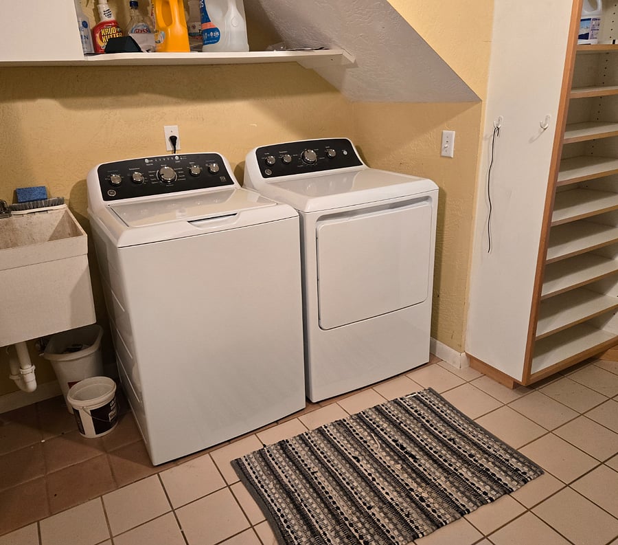Separate utility room with brand new W/D units and shelves for storage.