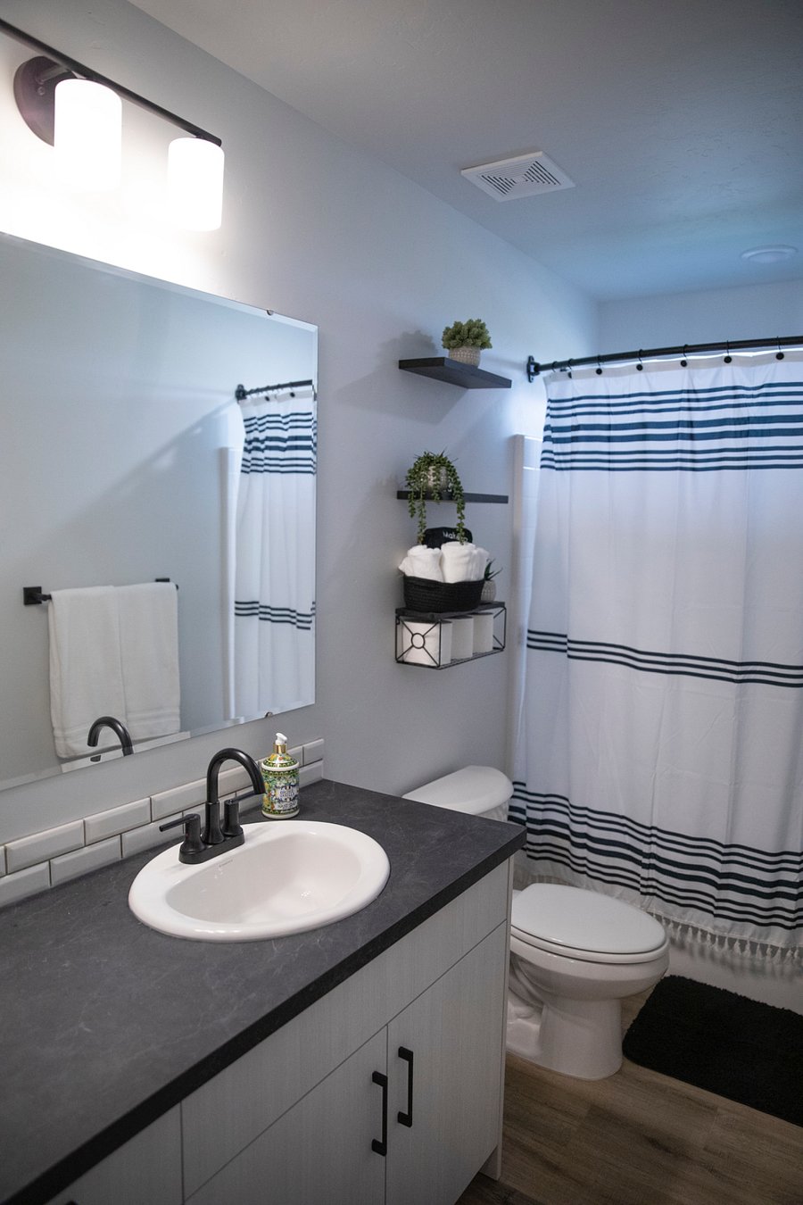 Upstairs bathroom with a full bathtub and shower. Under the sink we have a potty seat and a step stool for littles. 