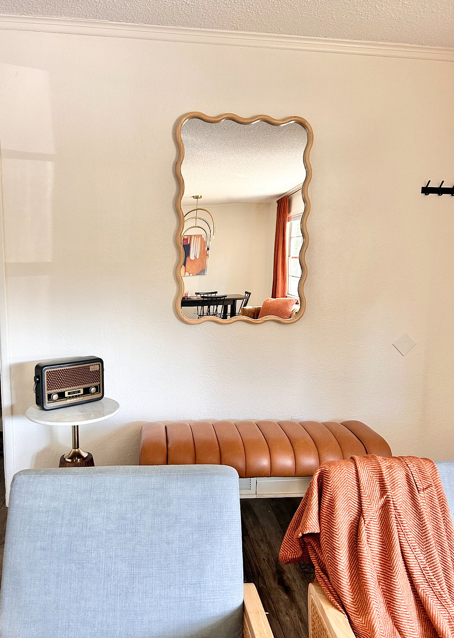 Entry way with fun mirror, hooks for coats and purses, comfortable bench and fun bluetooth speaker to listen to your favorite songs