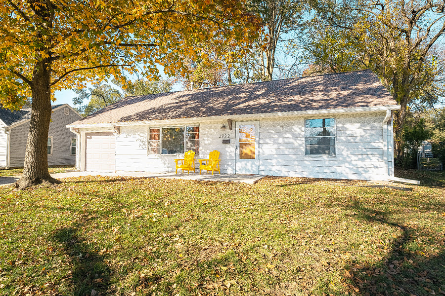 Large front yard with beautiful tree and 2 Adirondack chairs to enjoy the outdoors. 
