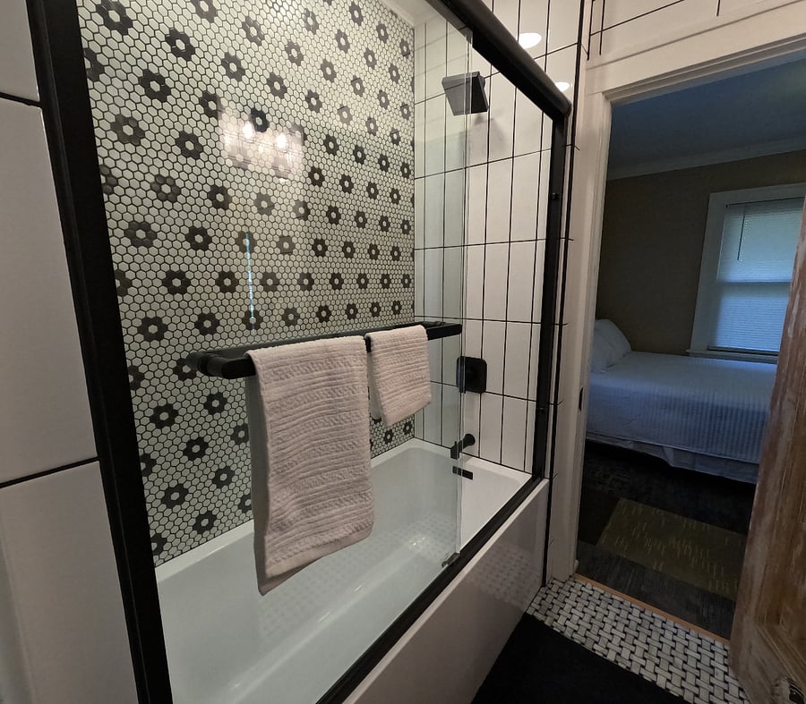 Beautifully remodeled Jack & Jill style bathroom with a fresh classic look & soft water shower..